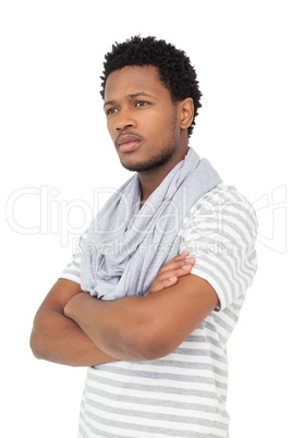 Thoughtful young man with arms crossed