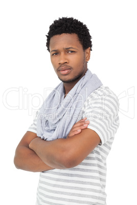Portrait of a serious young man with arms crossed