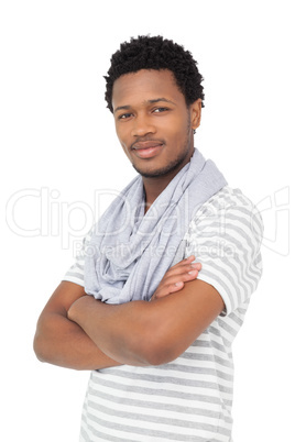 Portrait of a smiling young man with arms crossed
