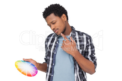 Young man looking paint samples