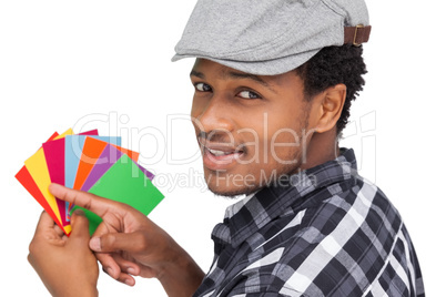 Portrait of a young man with colorful papers