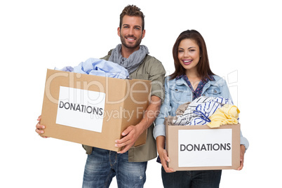 Portrait of a happy young couple with clothes donation