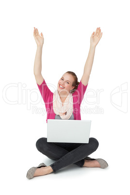 Hppy young woman with laptop raising hands