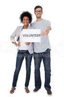 Portrait of a happy couple holding a volunteer note