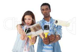 Portrait of a serious couple with painting tools