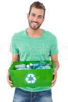 Portrait of a smiling man carrying recycle container