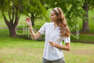 Woman holding a flower at park