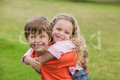 Two happy young kids playing at park