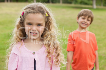 Two smiling kids standing at park Two smiling kids standing at park