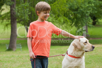Happy boy with pet dog at park