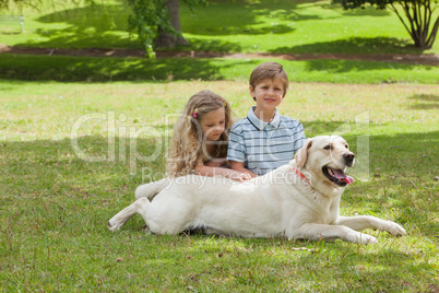 Portrait of kids with pet dog at park