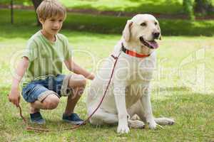 Young boy with pet dog at park