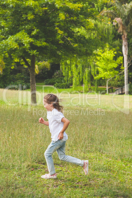 Side view of a young girl running at park