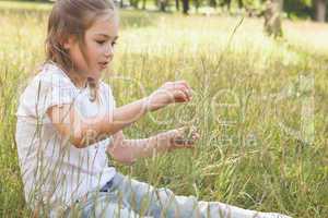 Relaxed young girl sitting in field