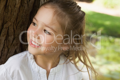 Smiling young girl looking away in park