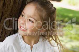 Smiling young girl looking away in park