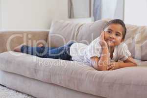 Relaxed young girl lying on sofa