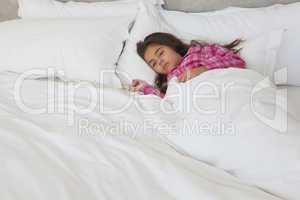 Young girl sleeping in bed at home