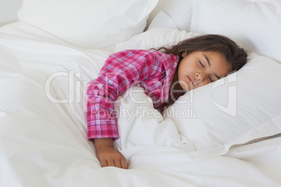 Young girl sleeping in bed at home