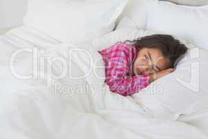 Young girl resting in bed at home
