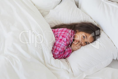 Portrait of a young girl resting in bed