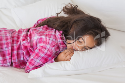 Young girl sleeping in bed