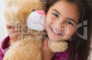Young smiling girl with stuffed toy