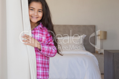 Portrait of a young smiling girl in bedroom