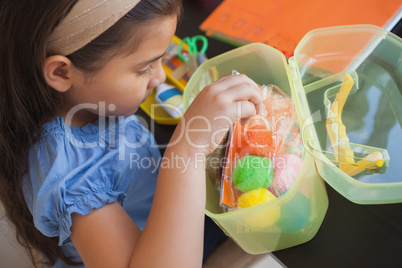 Young girl with colorful woolen balls