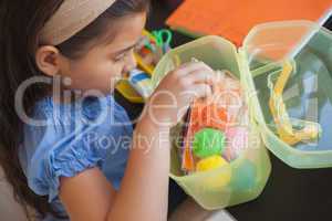 Young girl with colorful woolen balls