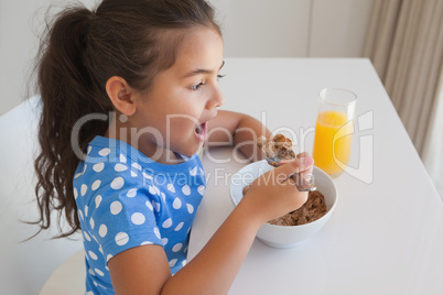 Side view of a girl having breakfast