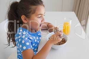 Side view of a girl having breakfast