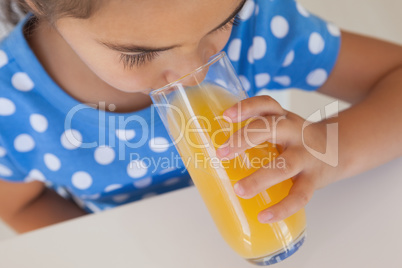 Close-up of a girl drinking orange juice