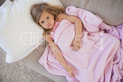 High angle portrait of cute girl resting on sofa