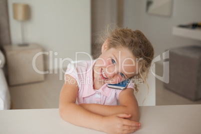 Smiling young girl using mobile phone