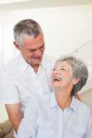 Retired couple embracing and smiling at each other