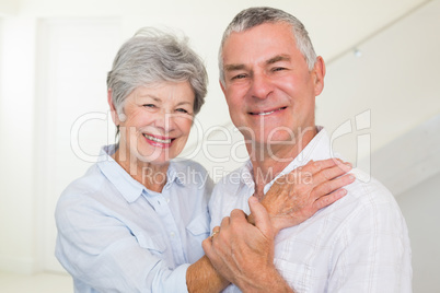 Cute retired couple smiling at camera