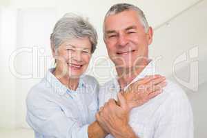 Cute retired couple smiling at camera