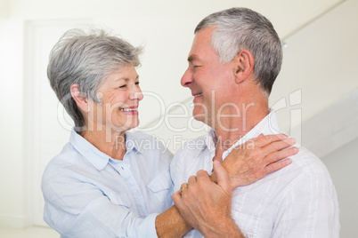 Affectionate retired couple smiling at each other