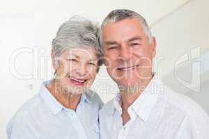 Happy retired couple smiling at camera