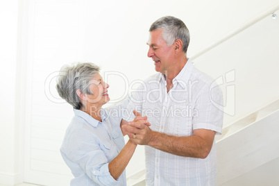 Cheerful senior couple dancing together
