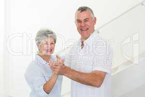 Happy senior couple dancing together