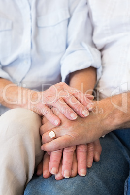 Retired couple holding hands