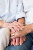 Retired couple holding hands