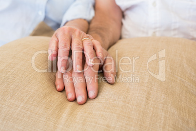 Retired couple holding hands