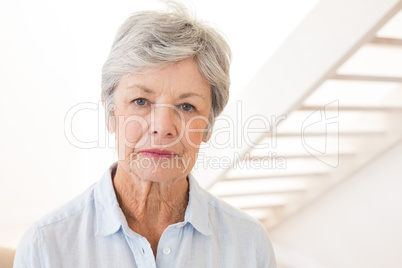 Retired woman frowning at the camera