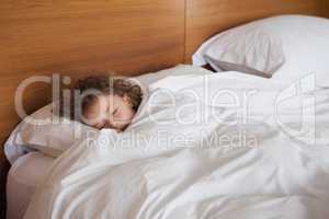 High angle view of a girl sleeping in bed