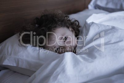 Close-up portrait of a girl resting in bed