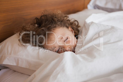 Close-up of a cute girl sleeping in bed