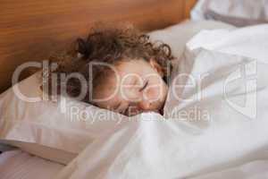 Close-up of a cute girl sleeping in bed